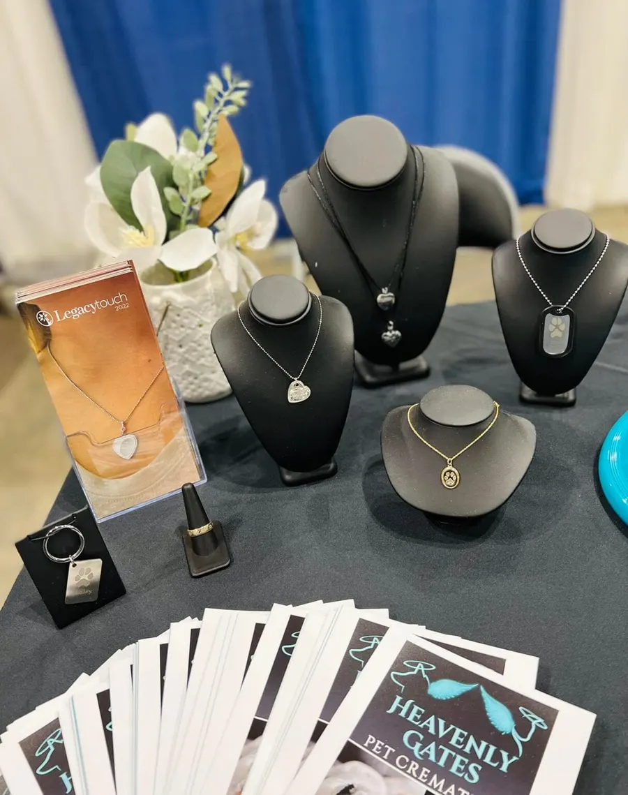 Keepsake necklaces and pendants displayed on black stands.
